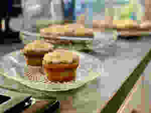 Two cupcakes on a pressed glass dish