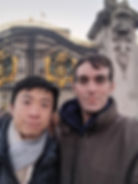 The author and his partner in front of the gates outside of Buckingham Palace in London.