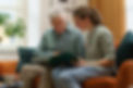 Young woman looking at a book with an elderly man