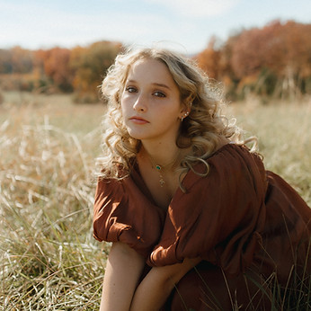 fall senior photo in grassy field