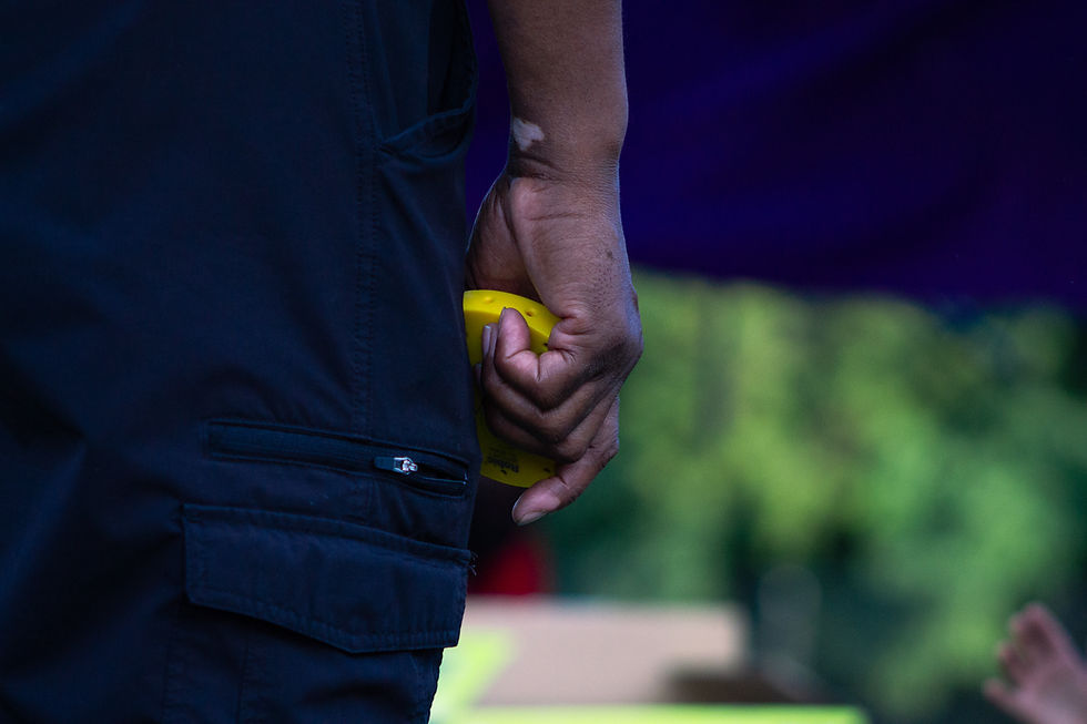 Coach Hrukti Maat holding a stop watch close up