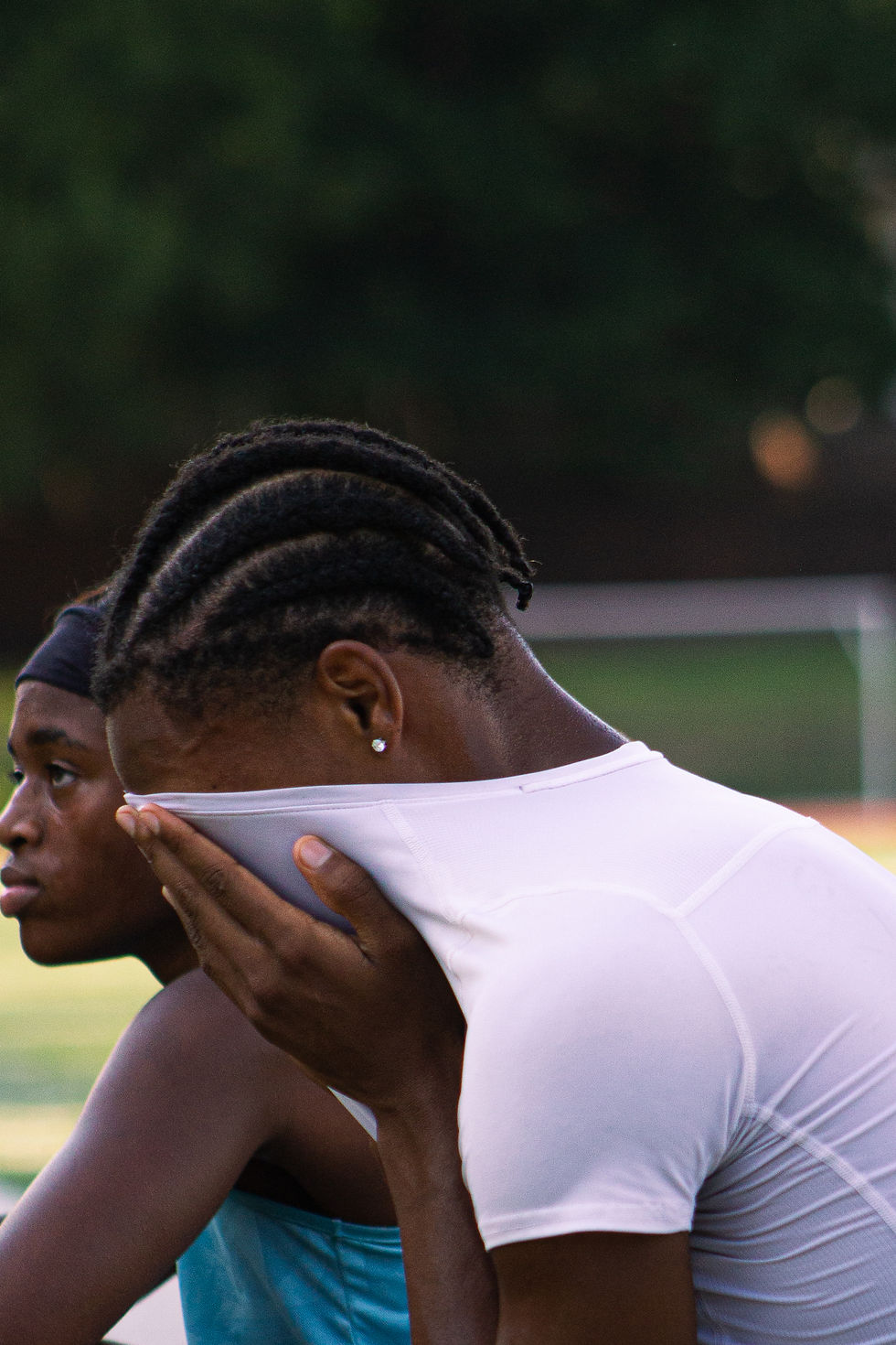 Memphis Mustangs athlete wiping face with jersey during practice