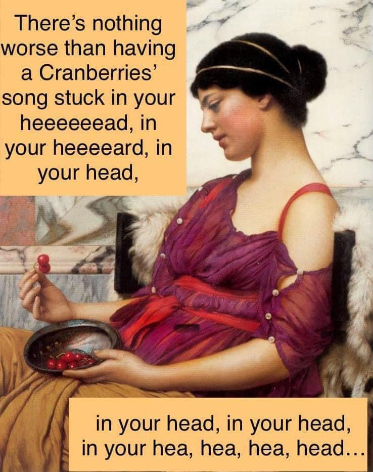 A woman in a purple dress holds cherries, sitting against a marble backdrop. Text humorously referencing a Cranberries song is overlayed.