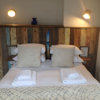 built in headboard in reclaimed timber and driftwood