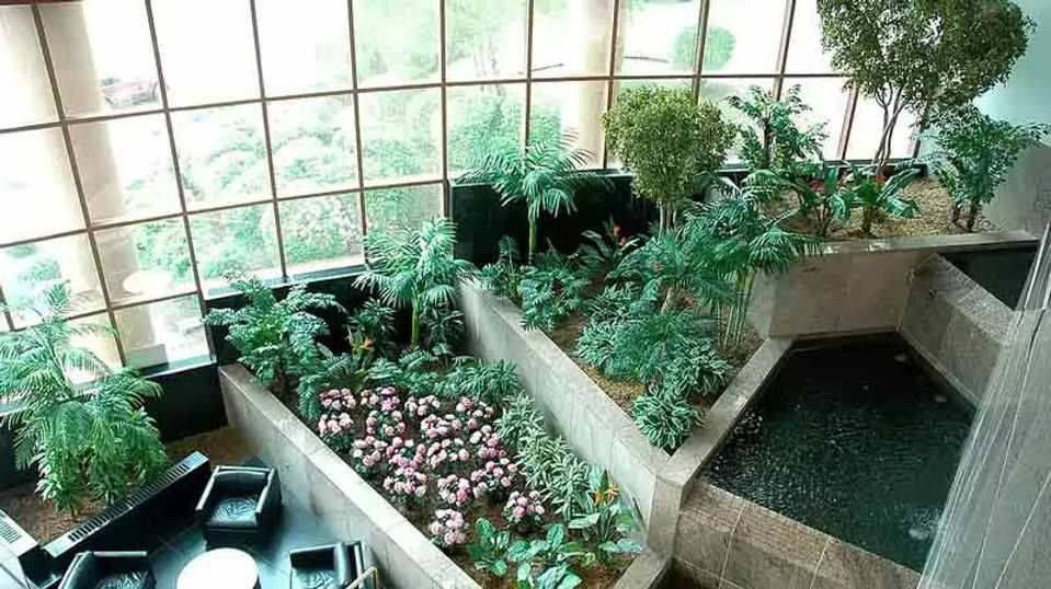 Indoor Garden with Tiered Planters and Seating by Grundys Plantscaping in Philadelphia, PA