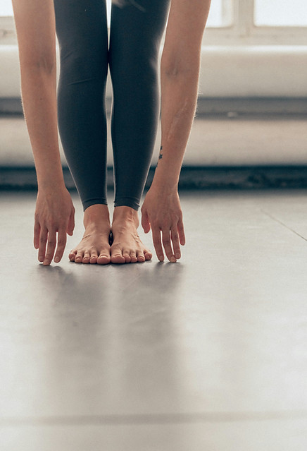 Person in a yoga forward fold — yoga therapy and mind-body healing in St. Petersburg, FL