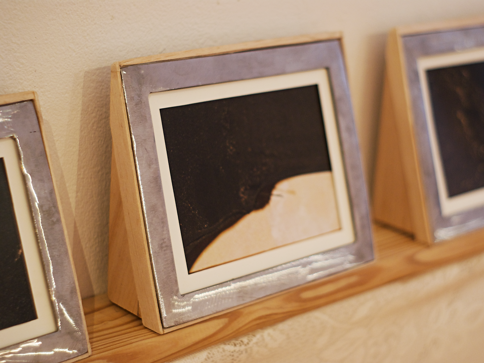 Constellations (1/6). Closeup images of an old chest binder inside of handmade wooden and metal frames.