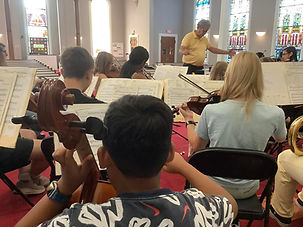 Student musicians rehearsing at summer orchestra camp.