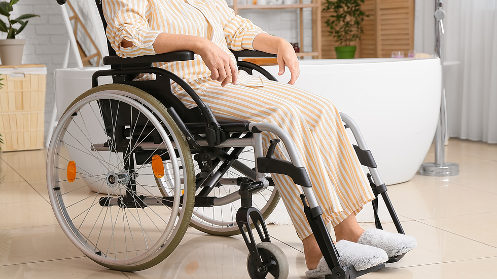 Home cleaninA person in a wheelchair using a bathroom with grab rails installed, looking comfortable and safe in a warm, accessible home environment.g