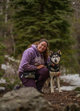 Photo of therapist Destyni Upton and her therapy dog, Katara in the outdoors of Utah