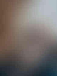 A woman at a hotel room reading Madison magazine