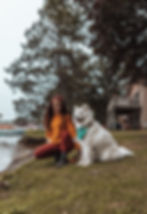 a girl with a dog by a lake