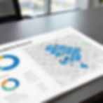 Printed property research report with a map and data charts on a desk
