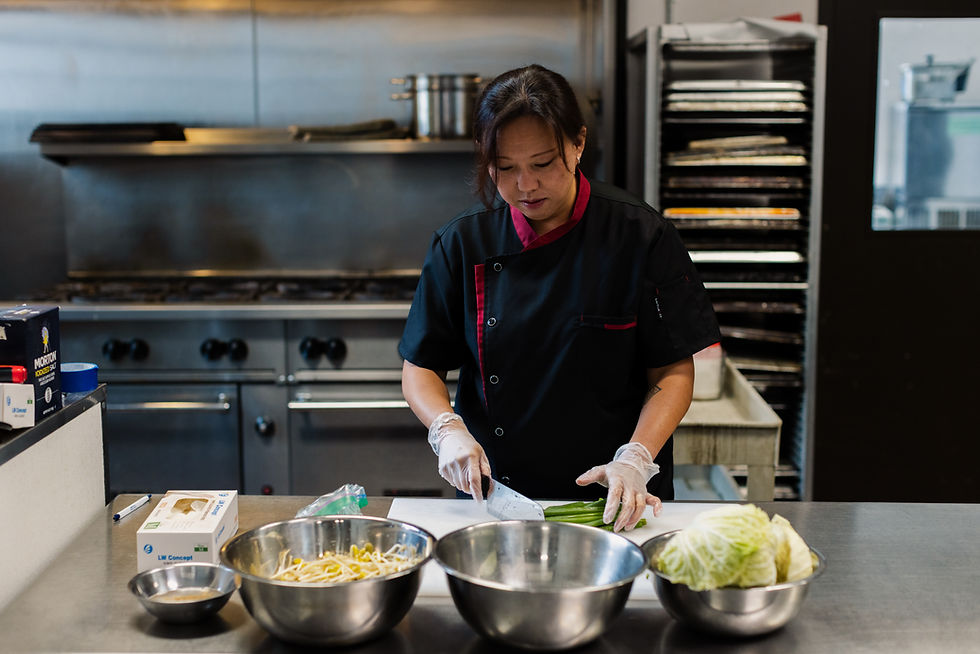 A chef chopping chives on a cutting board