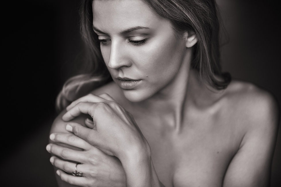 Naked women touching her shoulder.