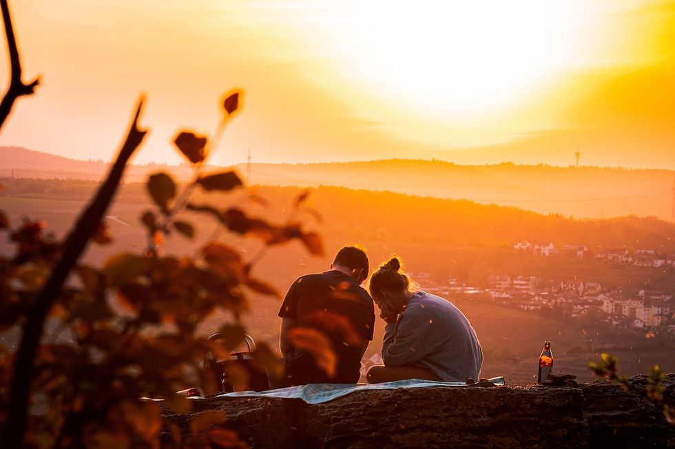 Couple on date while on holiday at sunset. Picnic date.