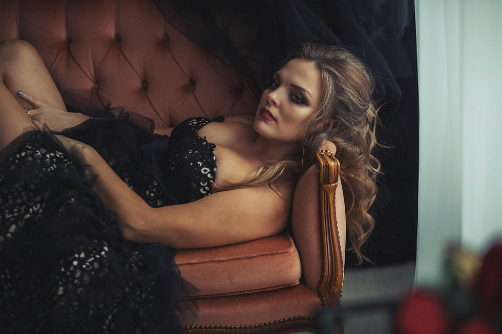 Sexy lady wearing black on a sofa