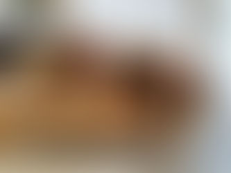 A lady on a sofa draping her body over with lingerie on