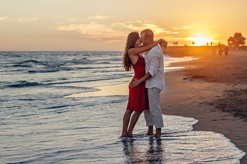 A couple embracing on a beach at sunset