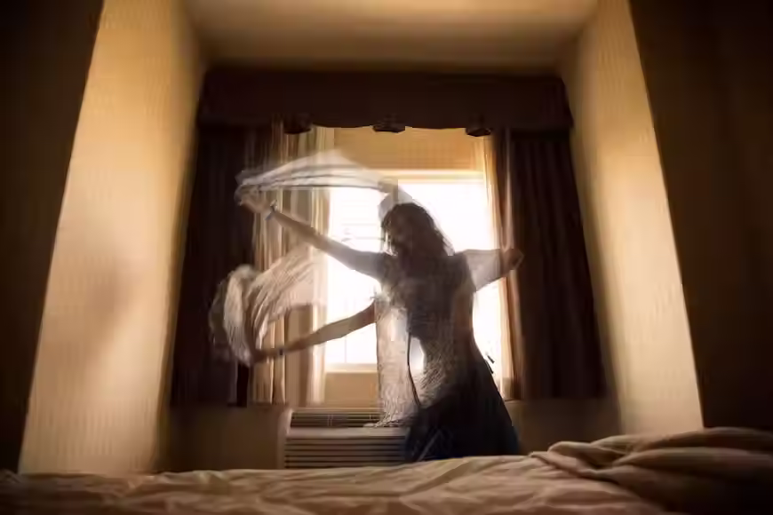 Somatic movement shakeout exercise woman bedroom motion blur, stress release physical decompression luxury home interior twilight.