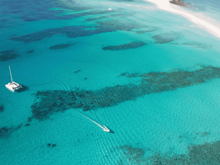 Catamaran au mouillage à Nosy Iranja dans un lagon turquoise, vue aérienne d’une croisière privée à Madagascar