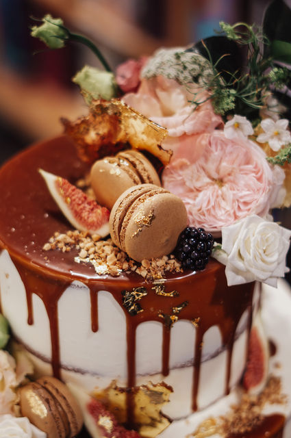 Rustic naked drip wedding cake fresh flowers and fruit