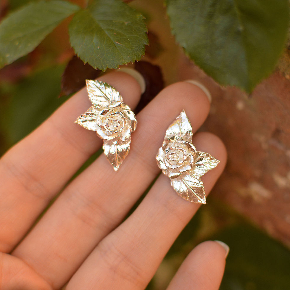 Thumbnail: Silver rose and leaf large stud earrings held in hand