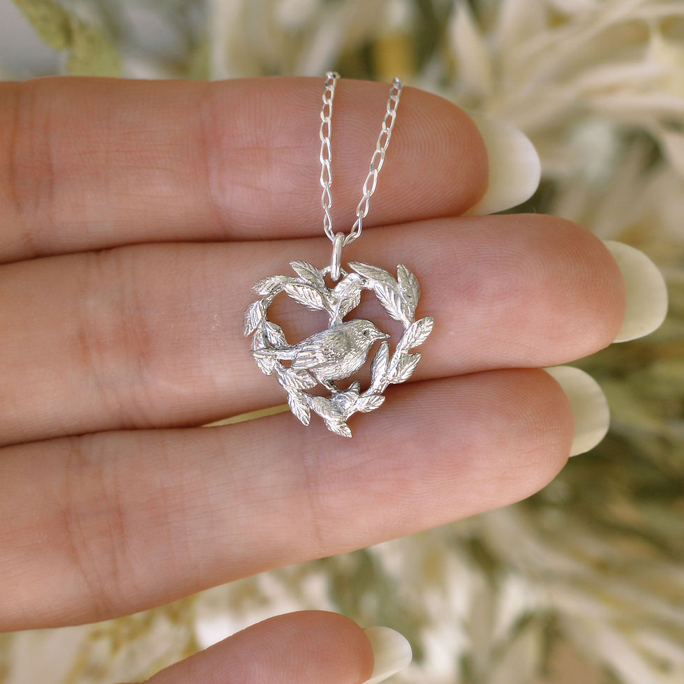 Thumbnail: Silver leaf heart and robin bird pendant on chain on a hand