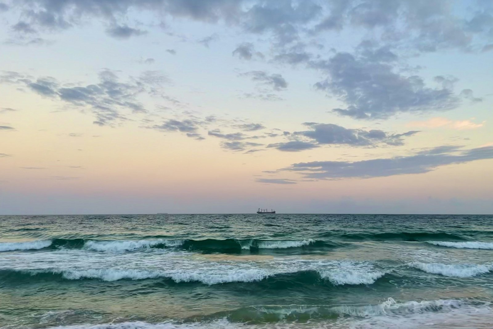 ocean waves under cloudy sky during daytime, empty of people