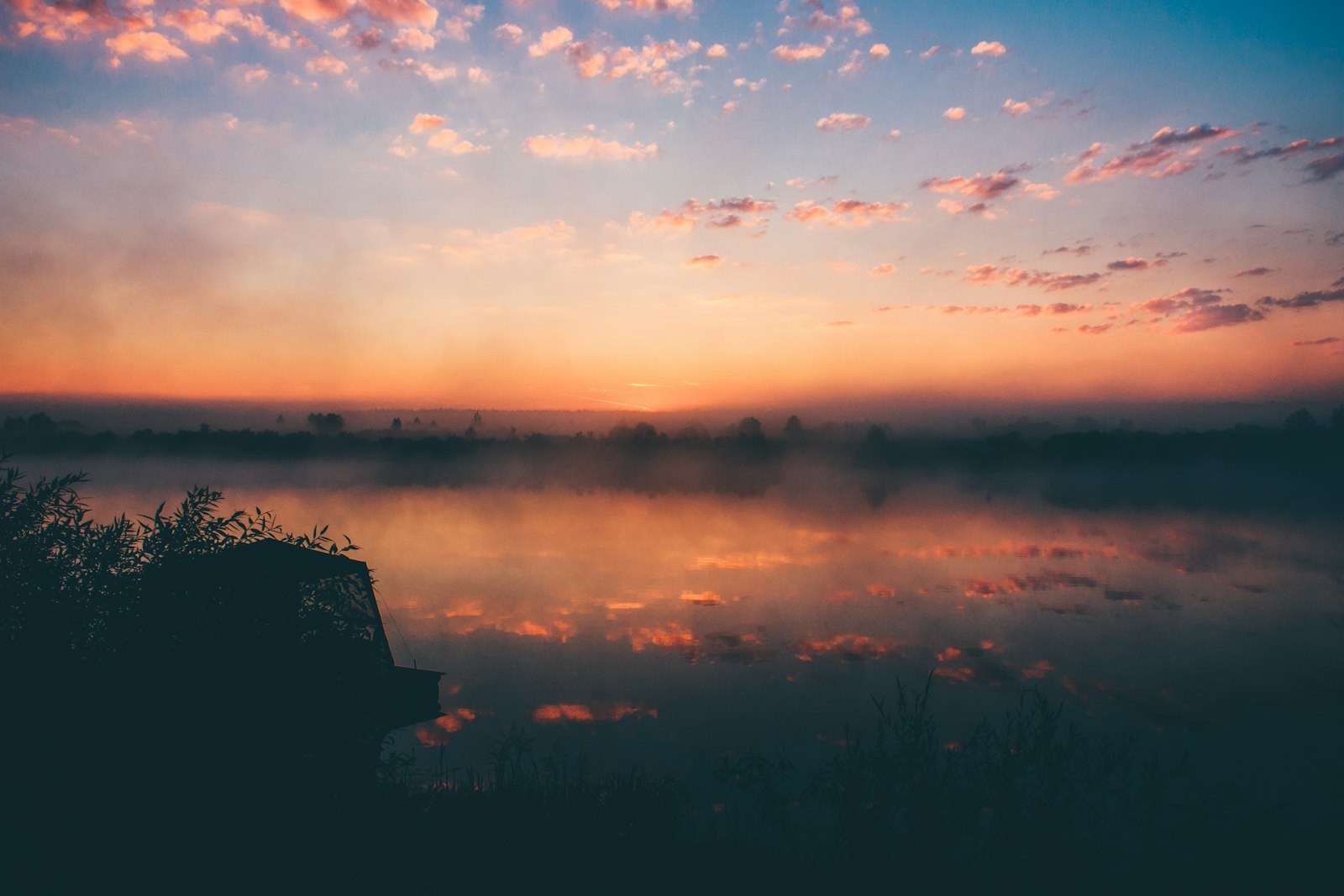 lake under white clouds during golden hour, empty of people