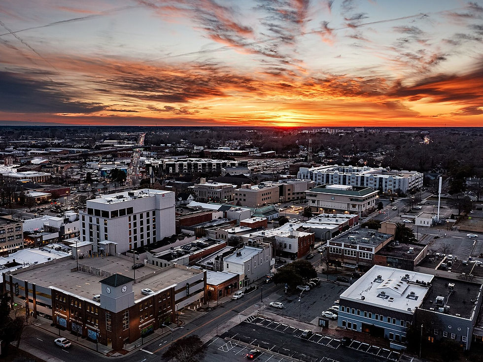 Downtown Greenville NC aerial at sunset with clock-tower block — no people as subject
