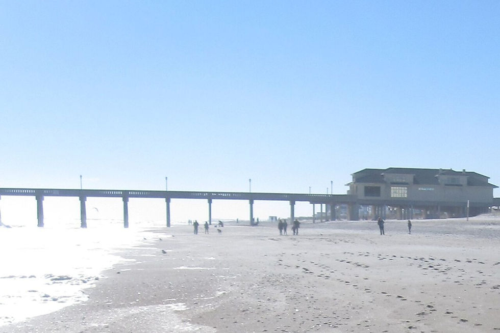 Johnnie Mercers Fishing Pier extending over the beach and Atlantic at Wrightsville Beach, North Carolina.