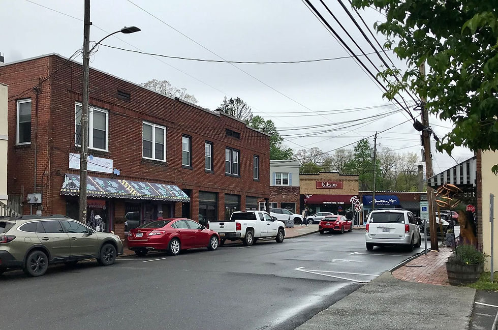 Historic brick storefronts with striped awnings on Cherry Street in downtown Black Mountain, North Carolina