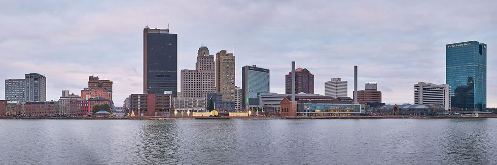 Panoramic view of the downtown Toledo skyline reflected across the calm Maumee River