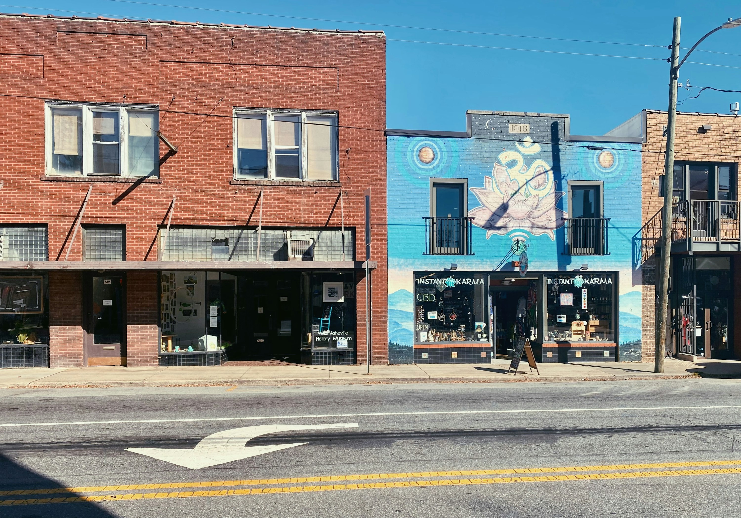 Mural-covered storefront on a Haywood Road side street in West Asheville, North Carolina