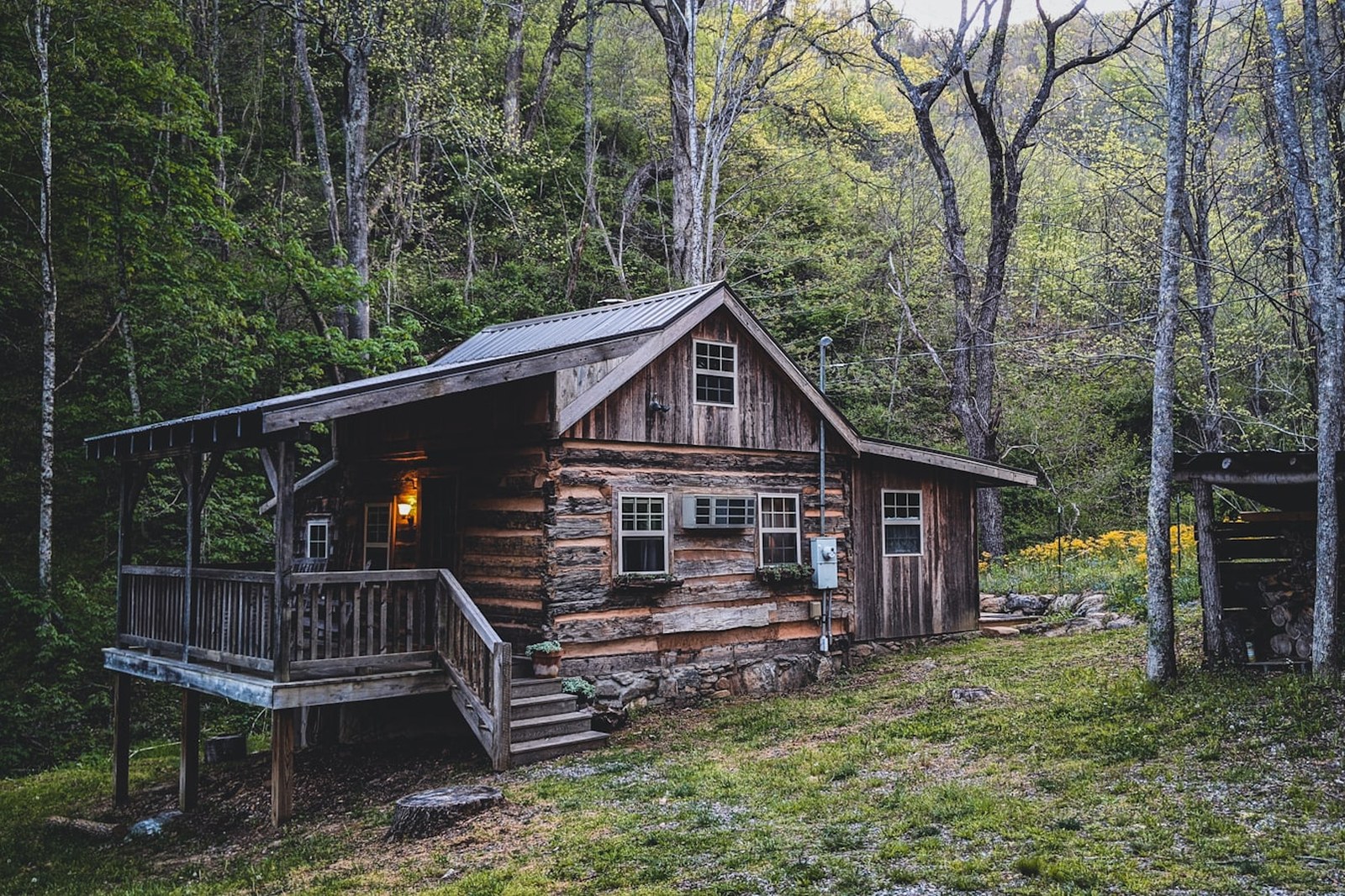 brown wooden house near green trees during daytime, empty of people
