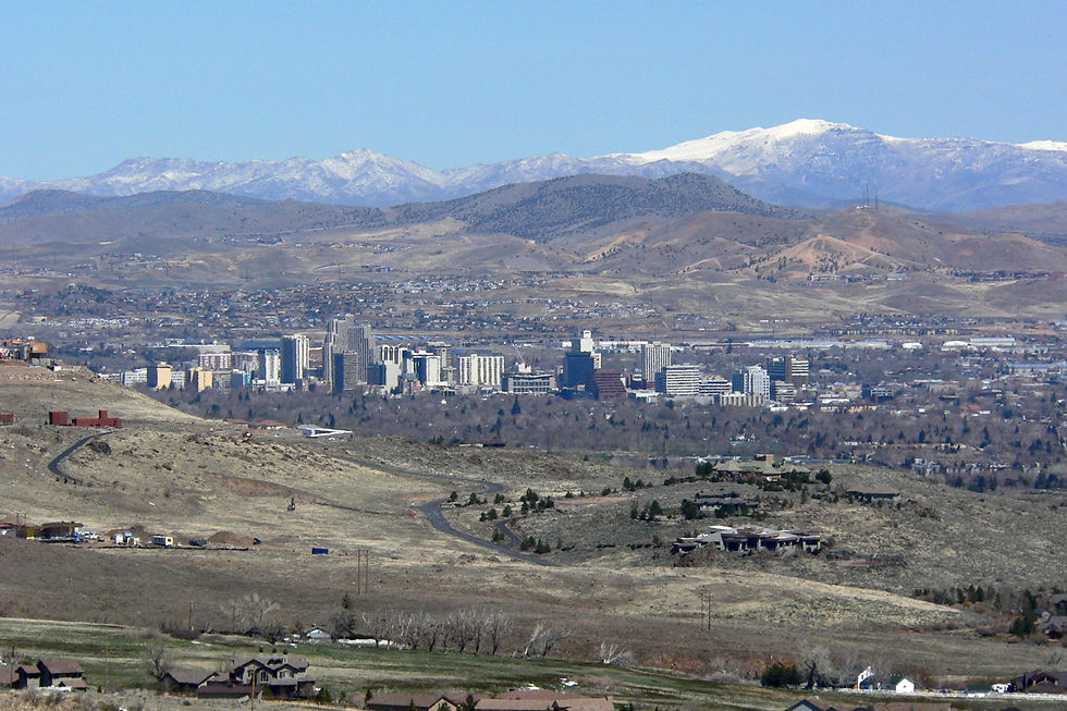 Downtown Reno, Nevada in the valley below snow capped Sierra foothills, seen from ArrowCreek