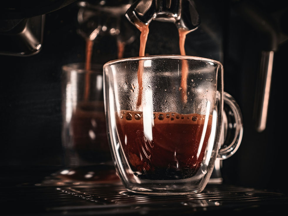 Coffee being poured into a glass mug