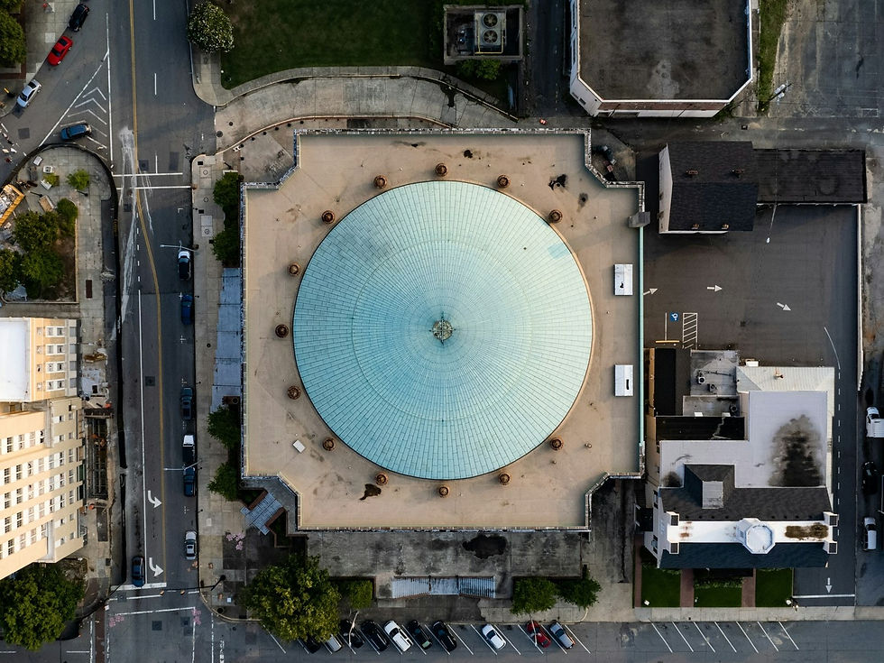 Aerial of Macon City Auditorium and downtown rooftops, Macon GA — buildings, no people as subject