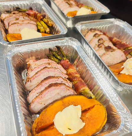 Boxed meal with sweet potato and ham.