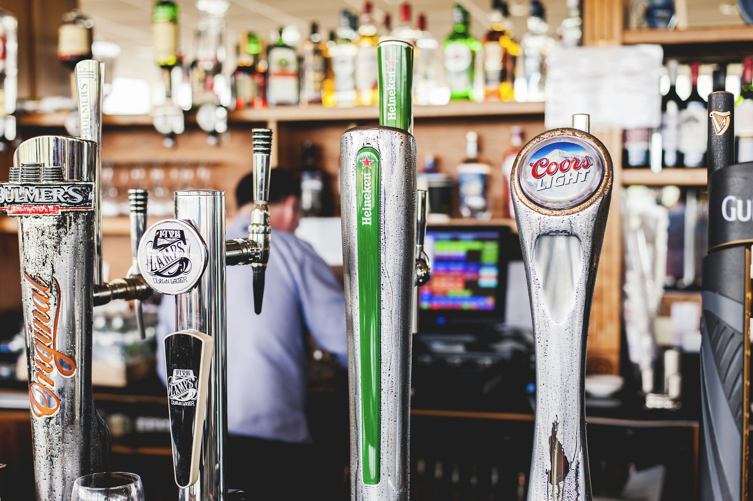 Row of craft beer tap handles at a brewery bar in Asheville, North Carolina