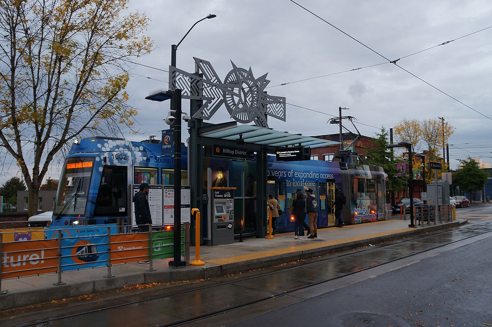 Streetcar stopped at the Hilltop District T Line station in Tacoma on a rainy afternoon