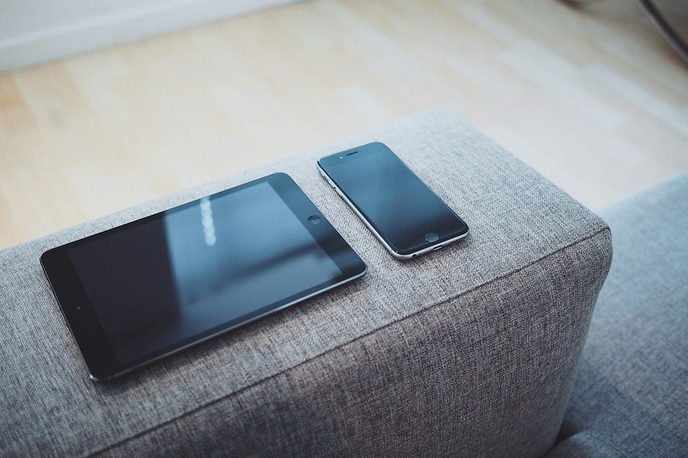 Turned off iPad And iPhone 6 on sofa arm