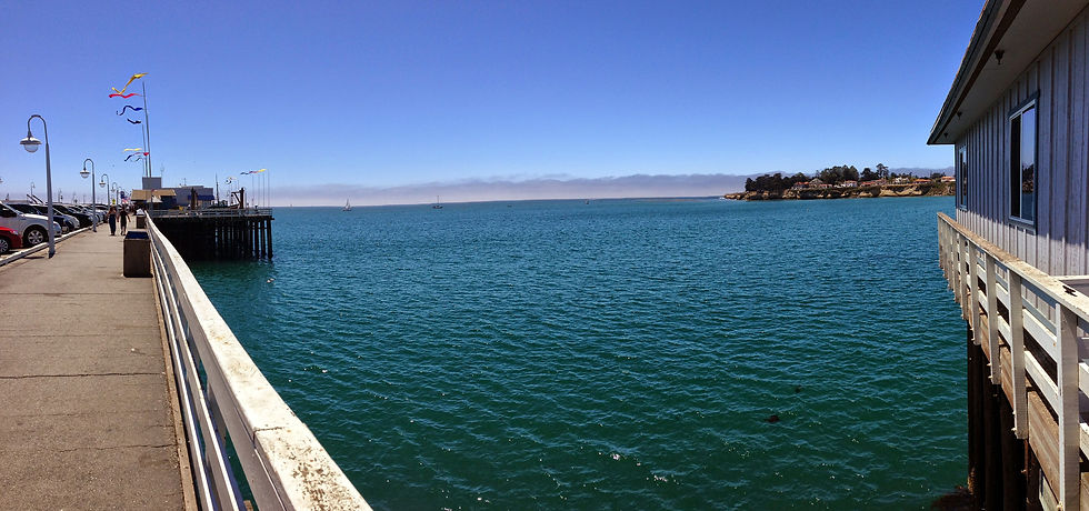 View along the Santa Cruz Wharf railing over calm blue water of Monterey Bay