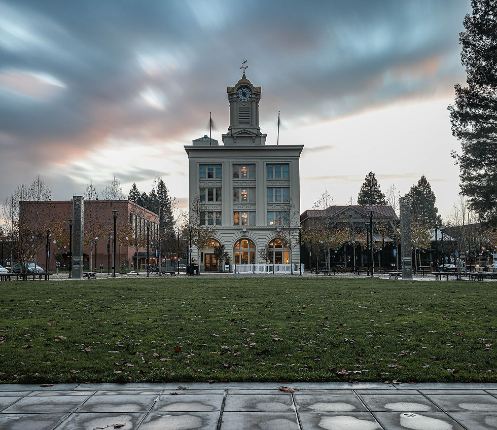 Historic Empire Building clock tower facing the green lawn of downtown Santa Rosa's square