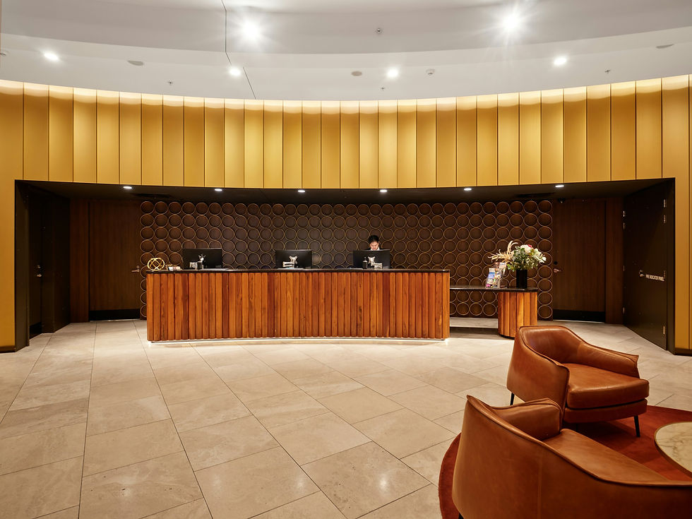 Modern boutique hotel reception desk with wooden furniture and seating, representing pricing and revenue management decisions made at the front desk