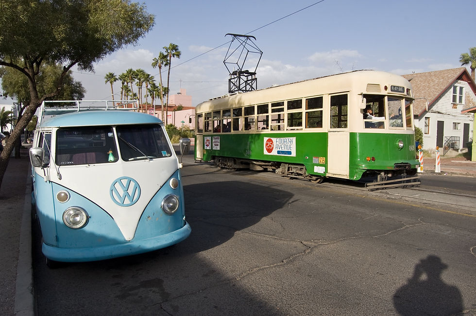 Vintage green streetcar and a classic blue van on Fourth Avenue in Tucson