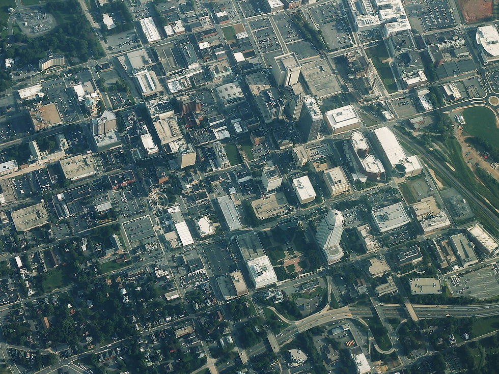 Downtown Winston-Salem aerial — roofs and towers, no people as subject