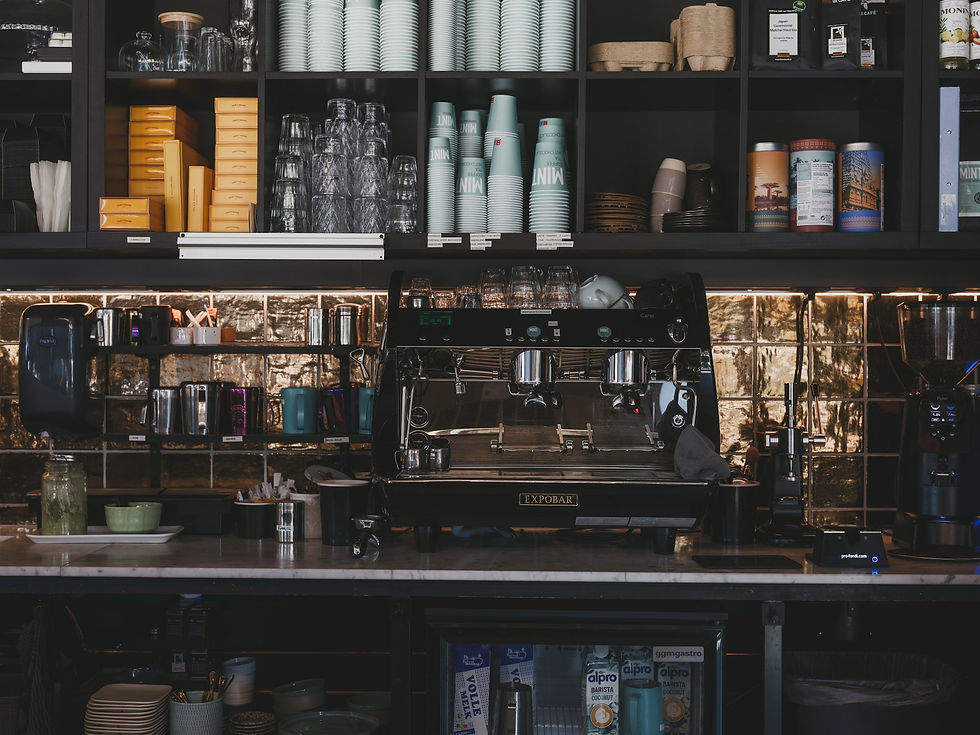 Espresso machine and shelves stocked with coffee supplies