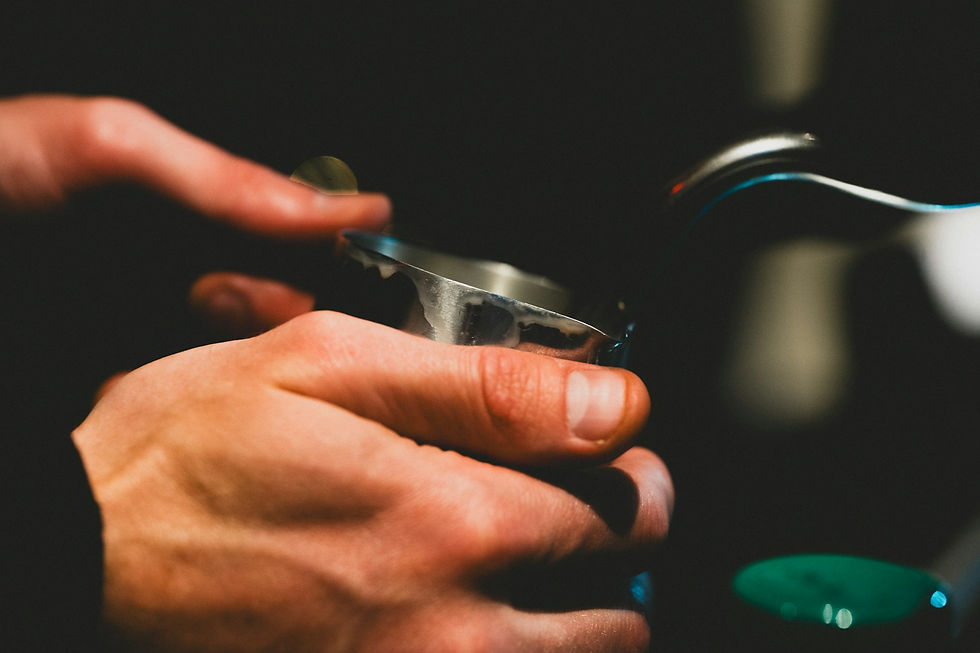 Barista tamping coffee grounds in portafilter